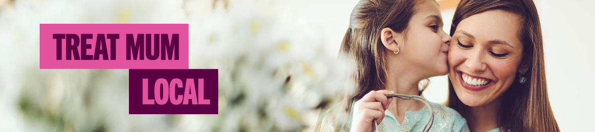 Daughter kissing mum on the cheek