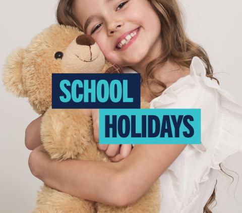 Girl hugging a teddy bear. Text 'School Holidays'.