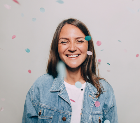 Woman smiling with confetti falling