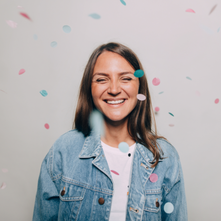 Woman smiling with confetti falling