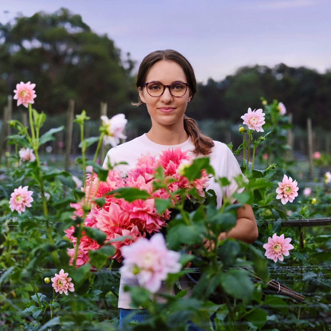 Woman in a flower field wearing OPSM glasses